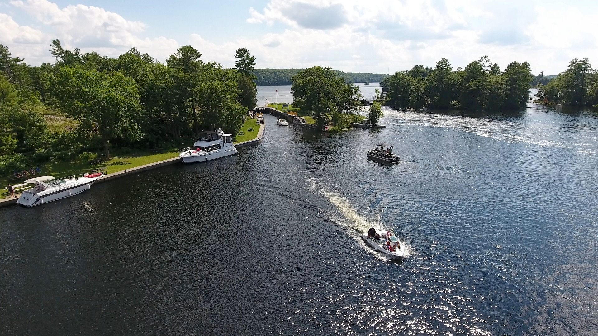 Boats sailing along the Trent-Severn Waterway on a summer day.