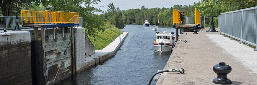 A boat sails into a lock on the Trent-Severn Waterway.