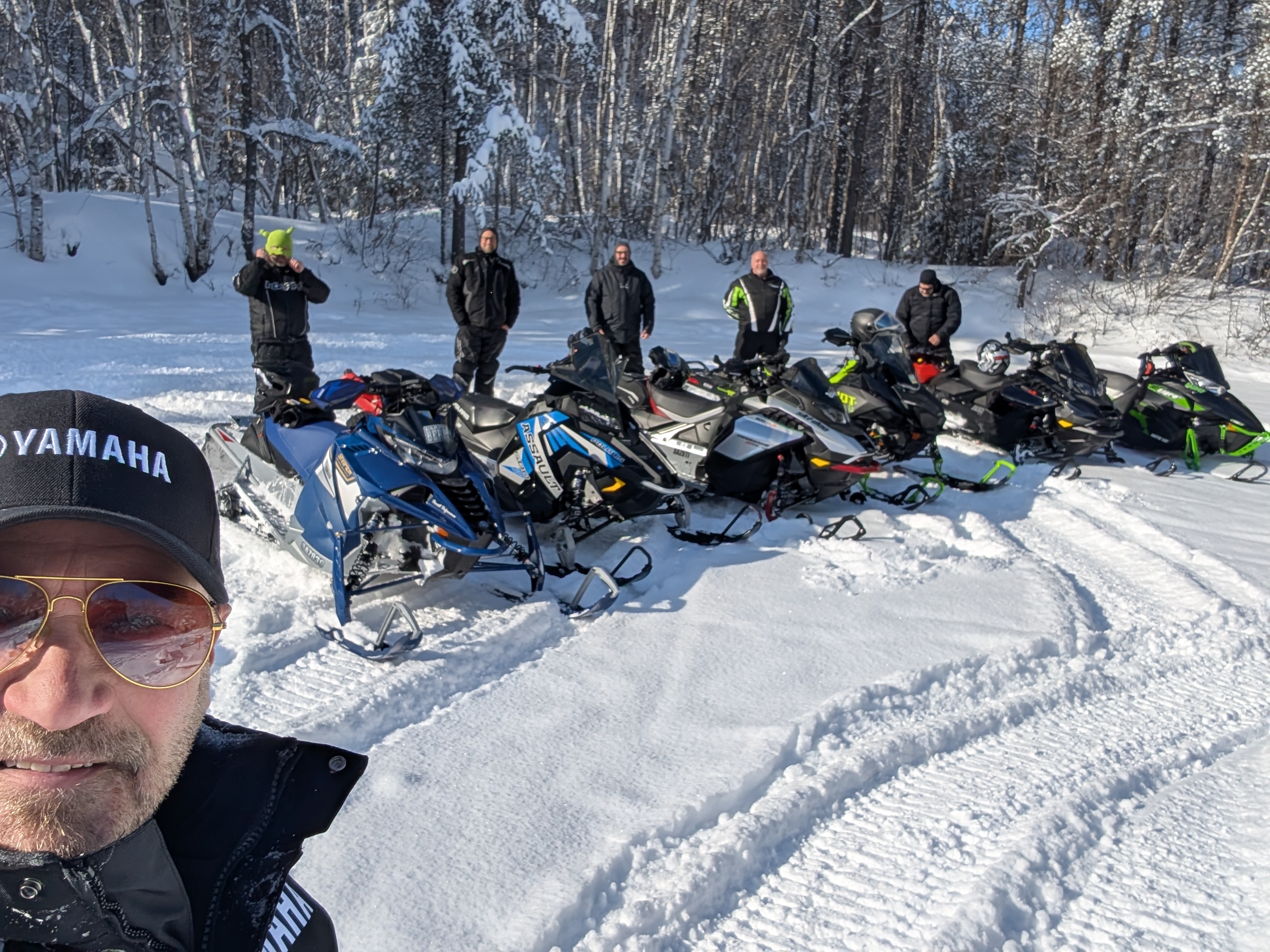 Larry Berrio snowmobiling with a group of friends.