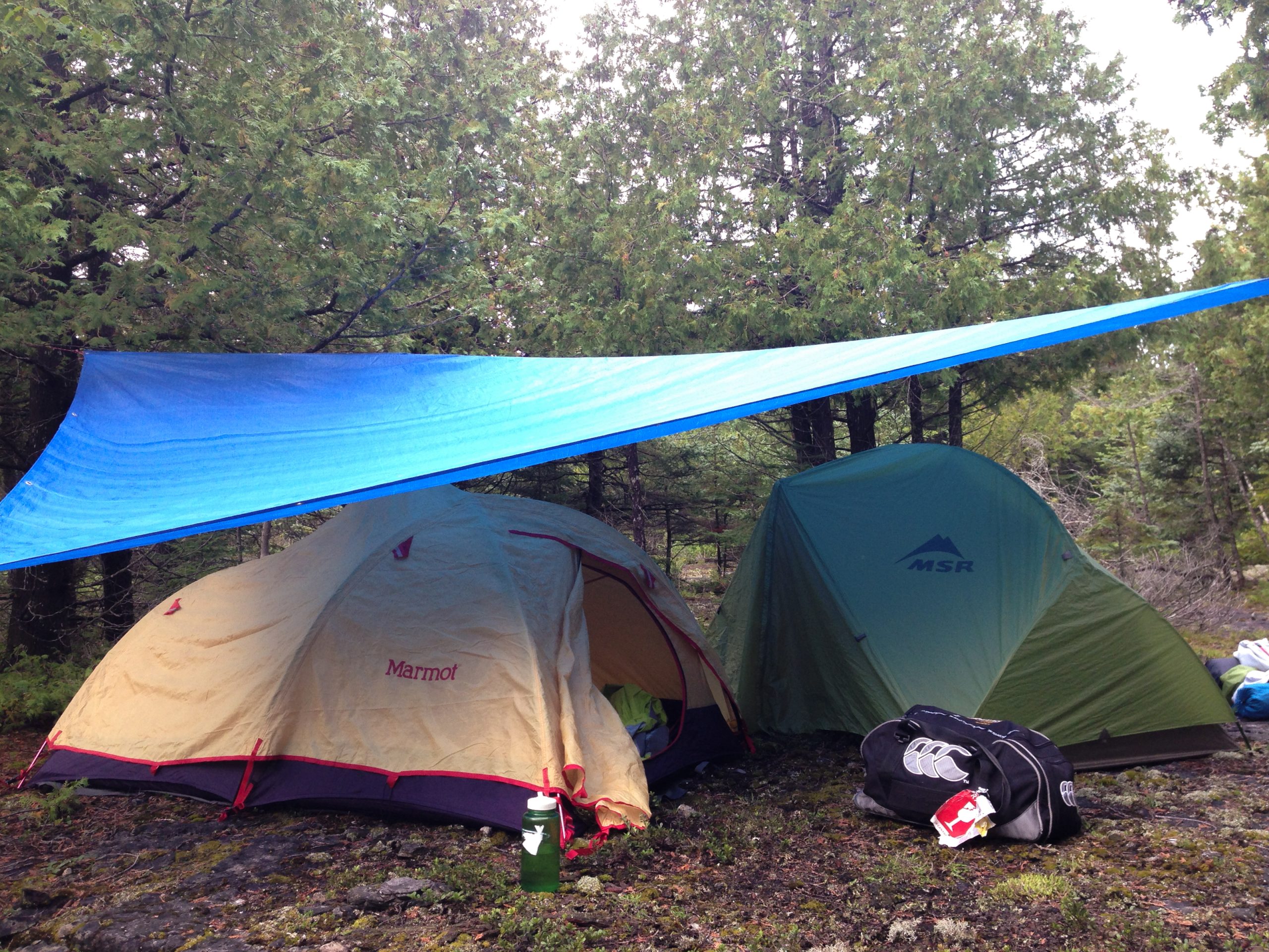 Two tents under a tarp