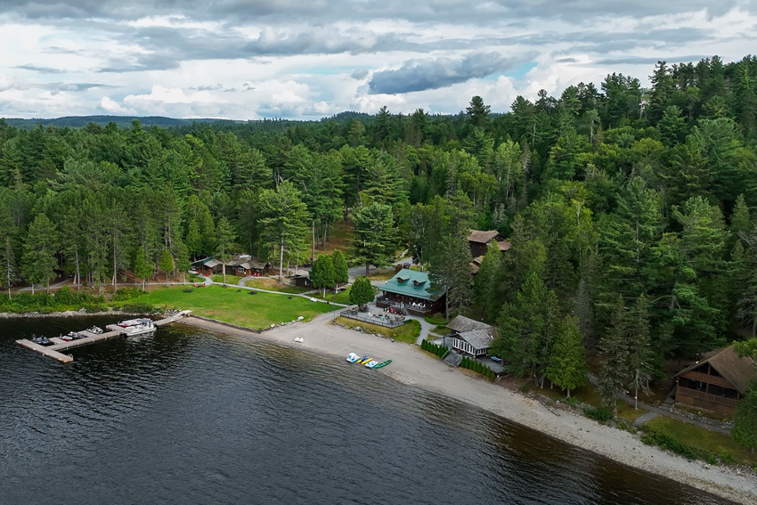 aerial of lodge on shoreline of lake