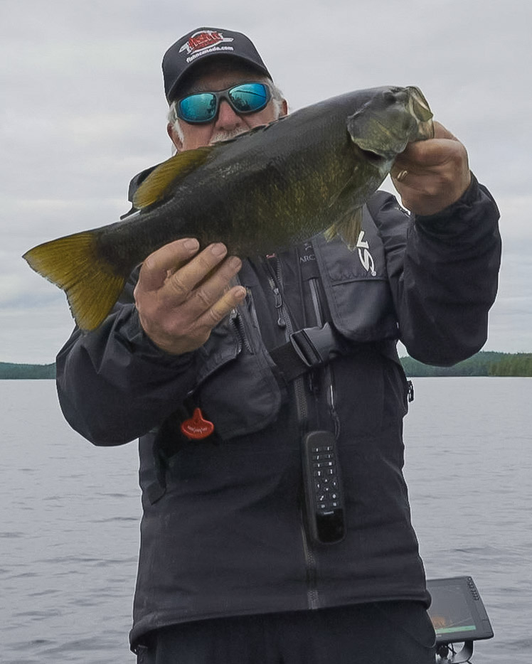 angler holding smallmouth bass