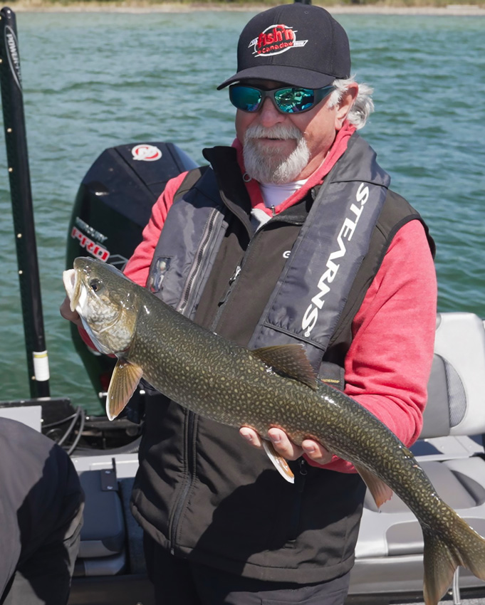 angler holding lake trout