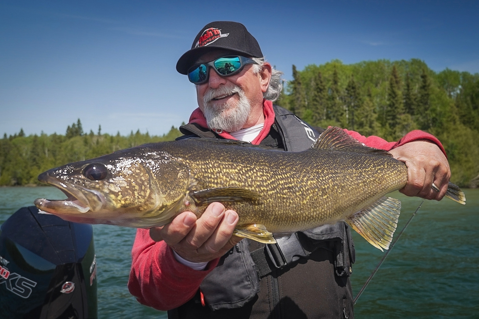 angler holding ontario walleye