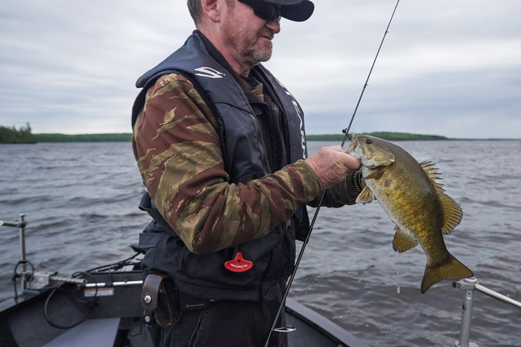 angler holding smallmouth bass