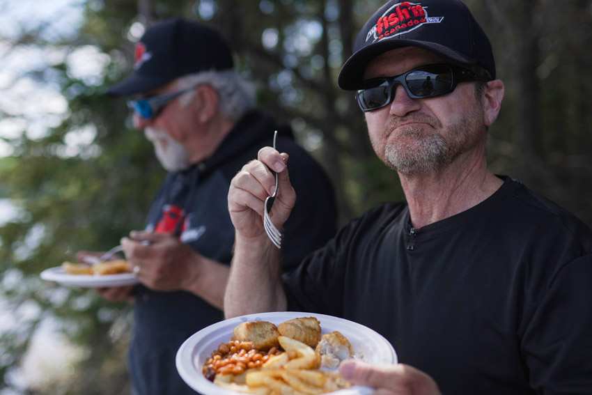 anglers eating shore lunch meal