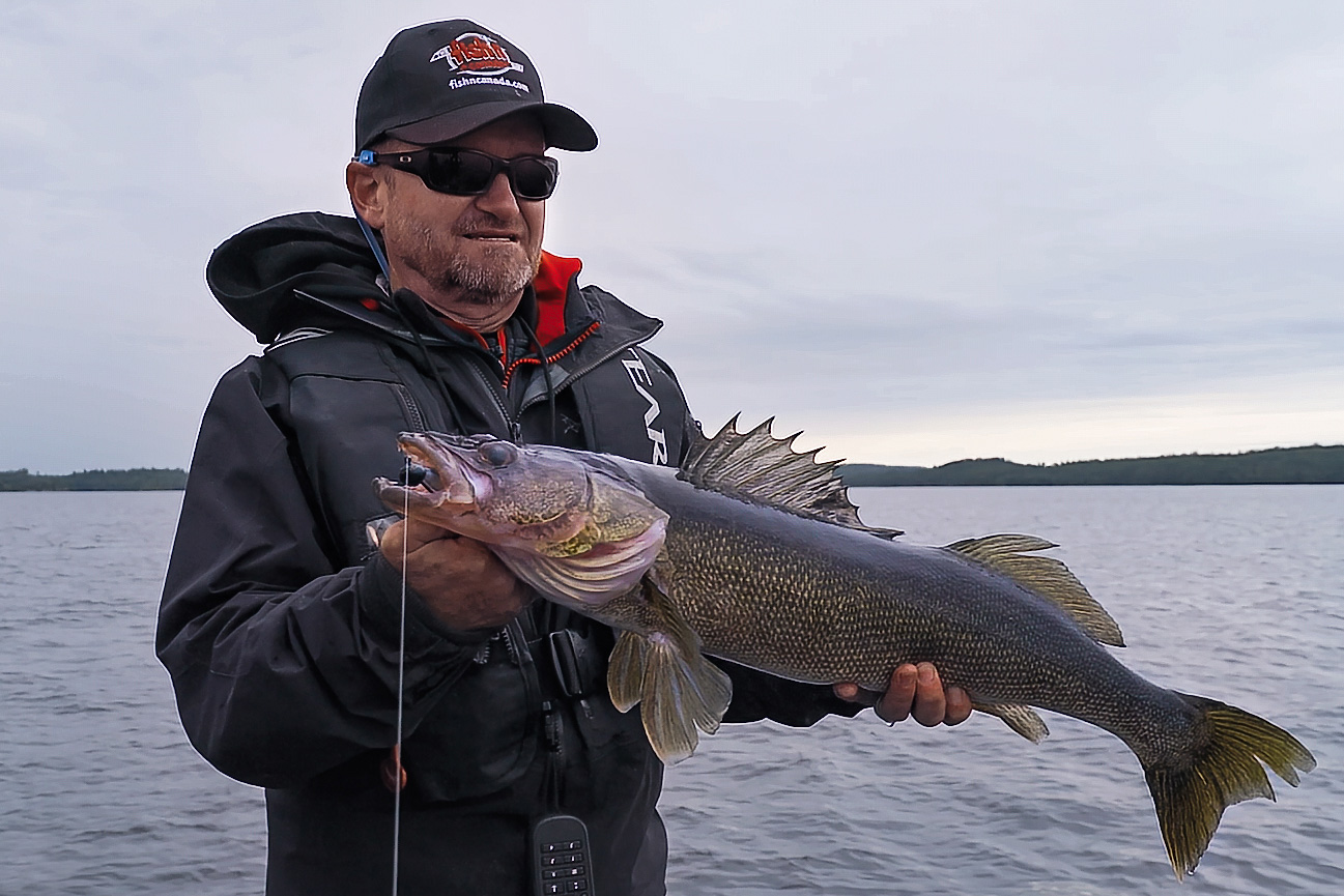 angler holding walleye