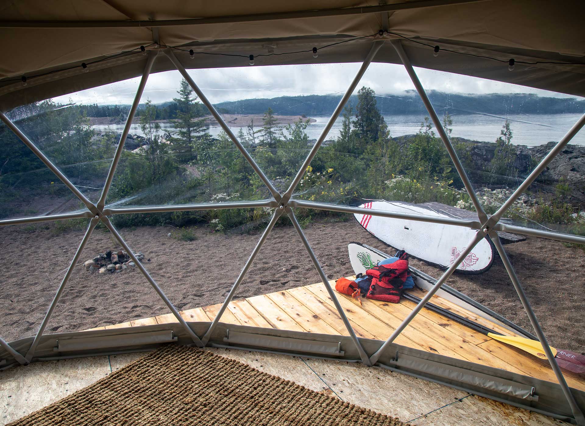 view from inside a glamping dome looking out at water