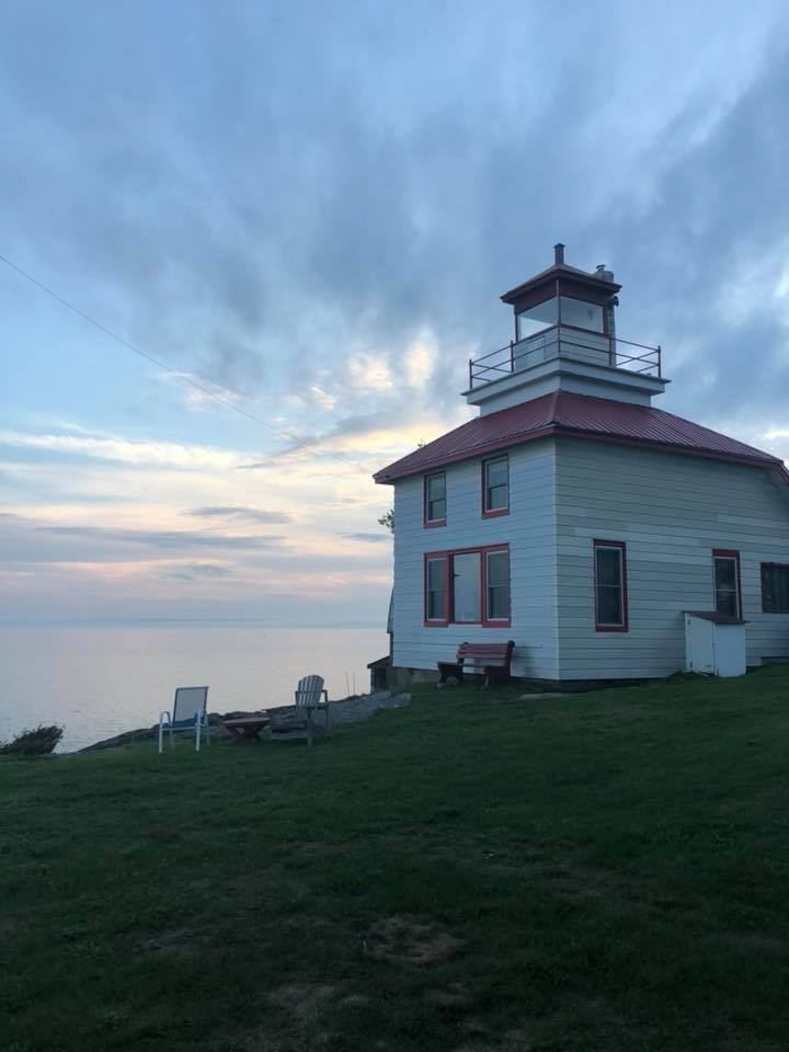 a square wooden lighthouse with red roof at Bruce Bay Cottages.
