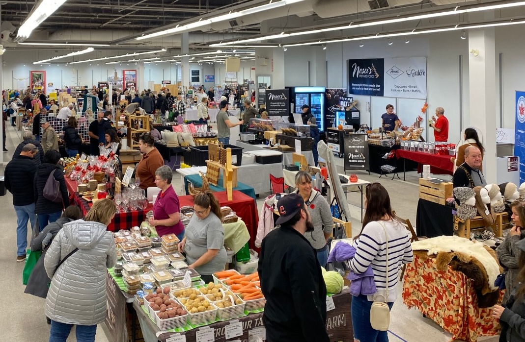 shoppers peruse rows of tables filled with produce, baked and handmade goods at the Sudbury Market.