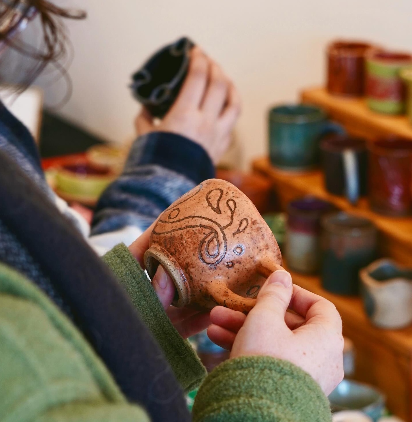 shoppers look at handmade pottery at Amberhill Gallery.