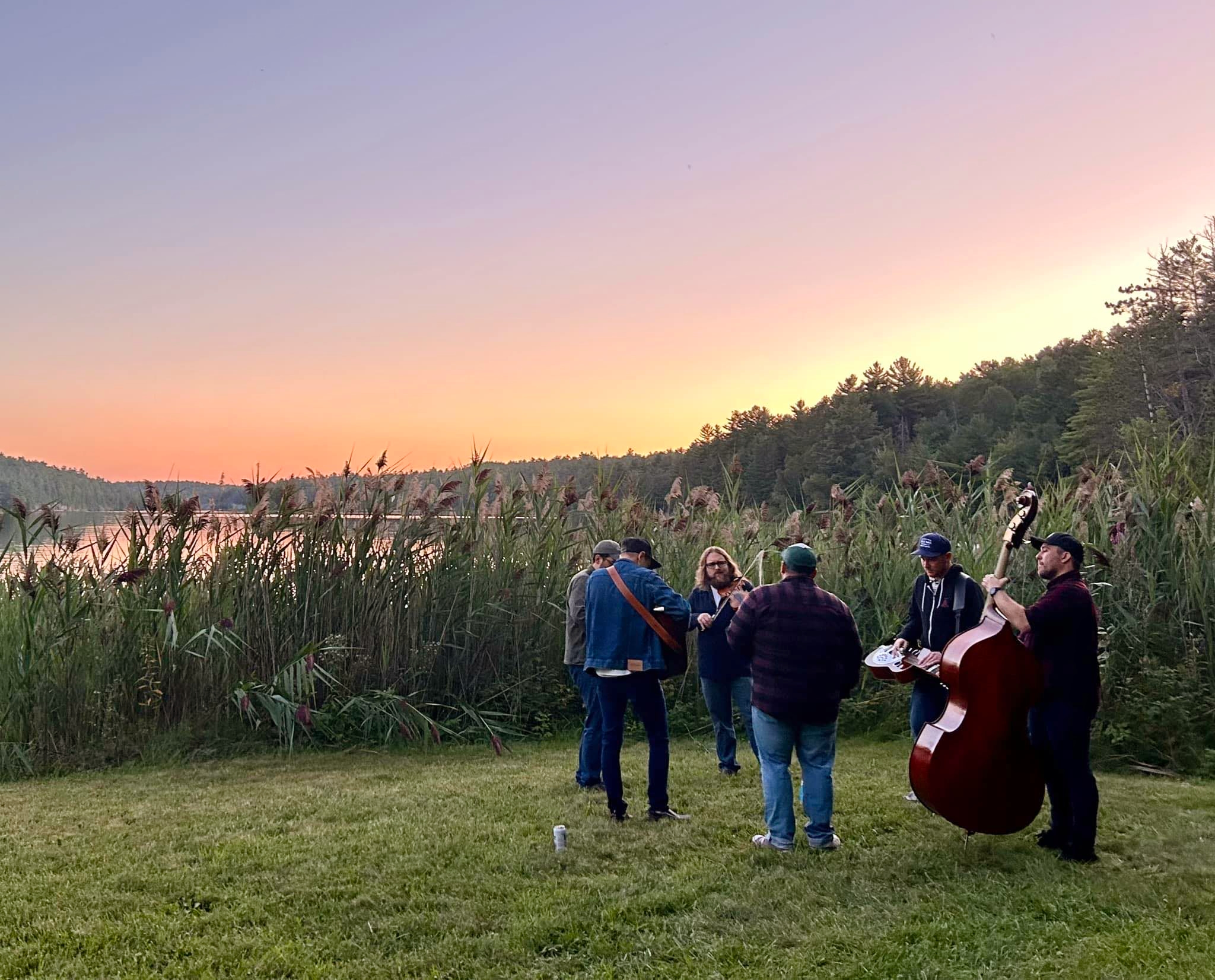 bluegrass musicians playing outdoors as the sun sets