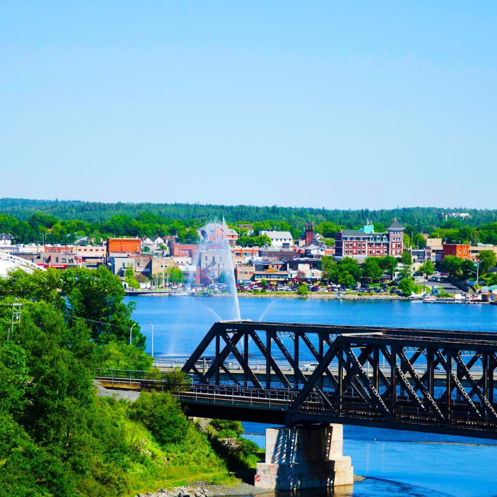 Kenora with green trees and a blazing blue summer sky.