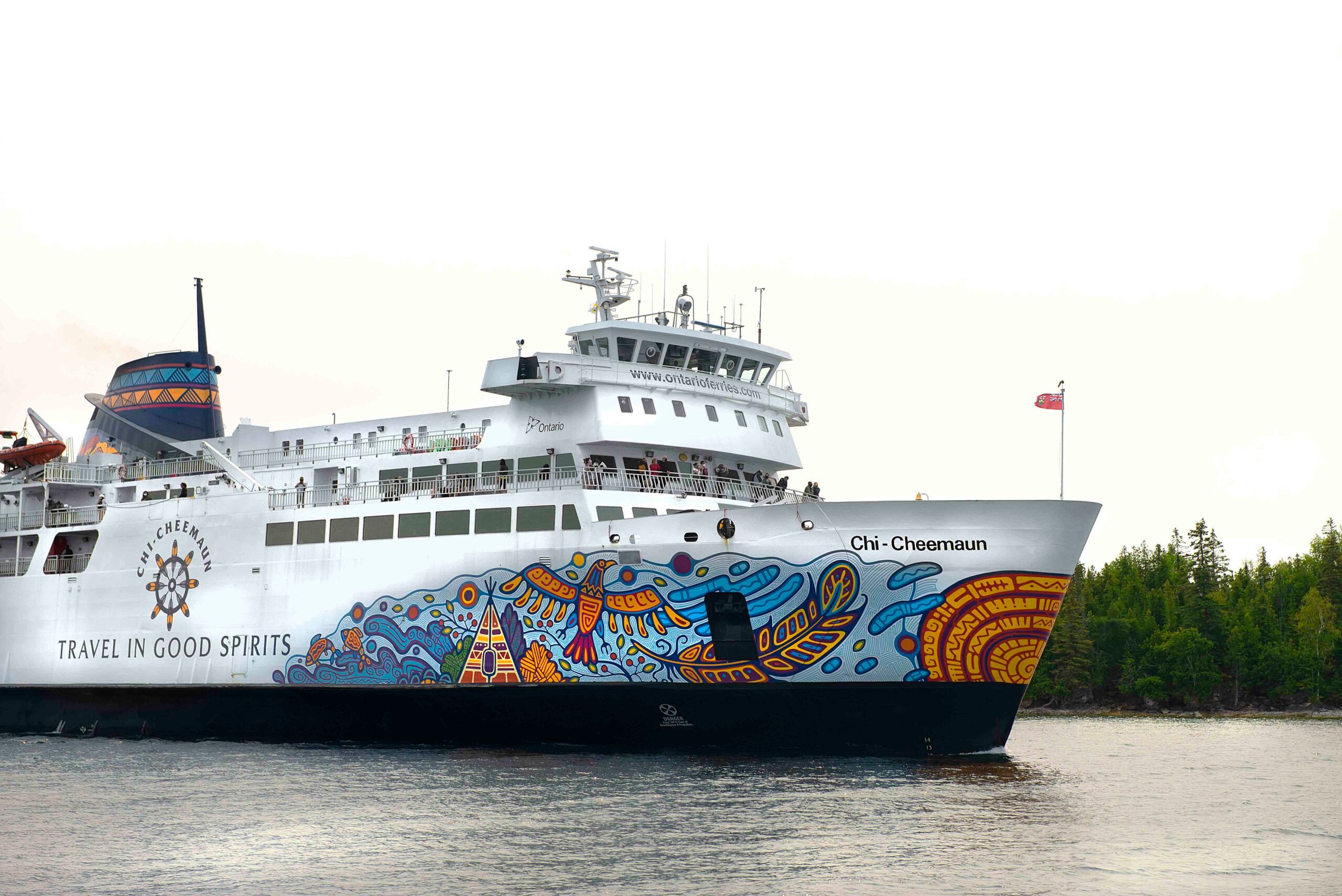 The MS Chi-Cheemaun Ferry, a large white passenger boat painted with a beautiful eagle and feather motif.