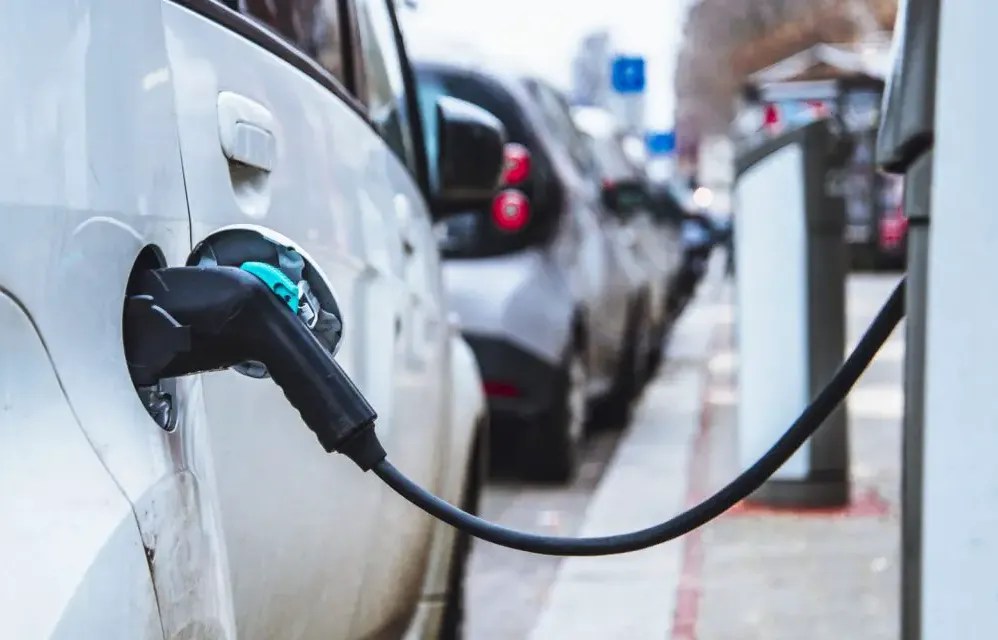 cars hooked up to EV charging stations