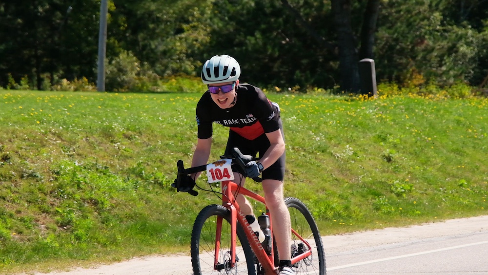 Person riding bike and smiling at camera