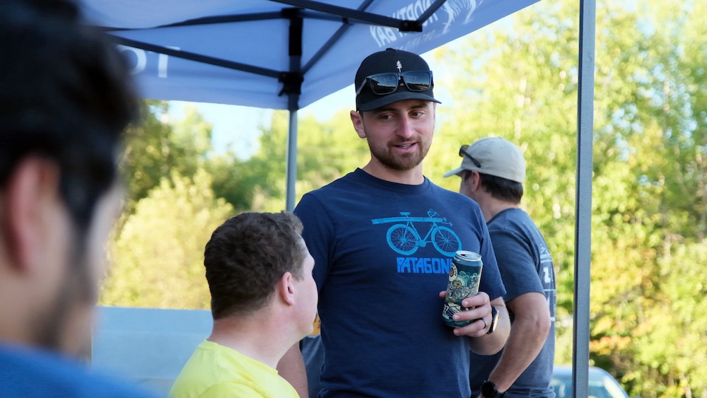 Person holding beer and talking to someone