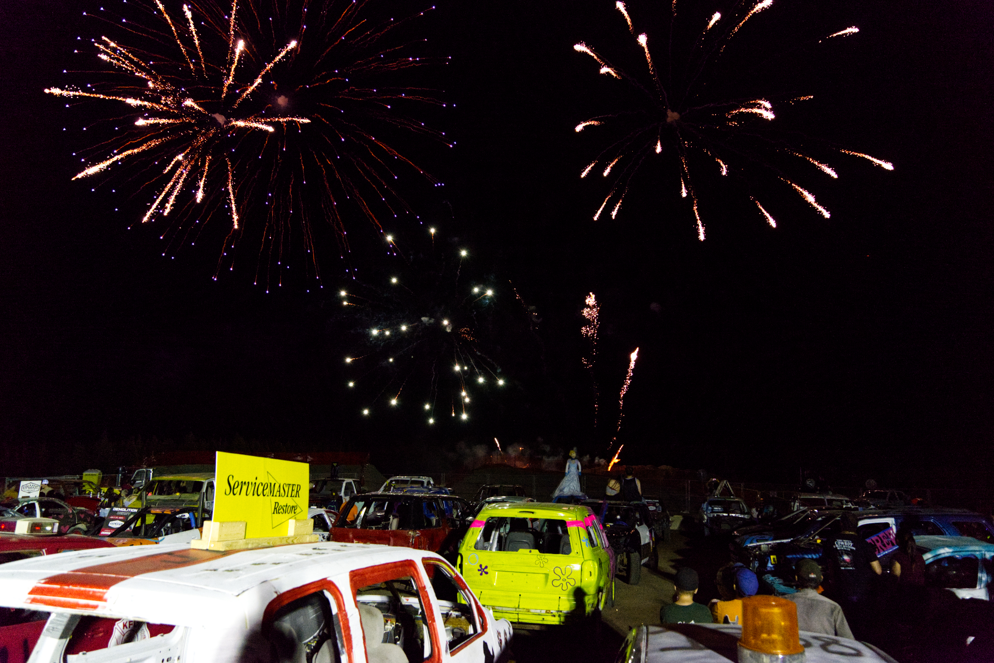 fireworks explode in the night sky over a sea of parked cars at the Kap Kraze Derby.