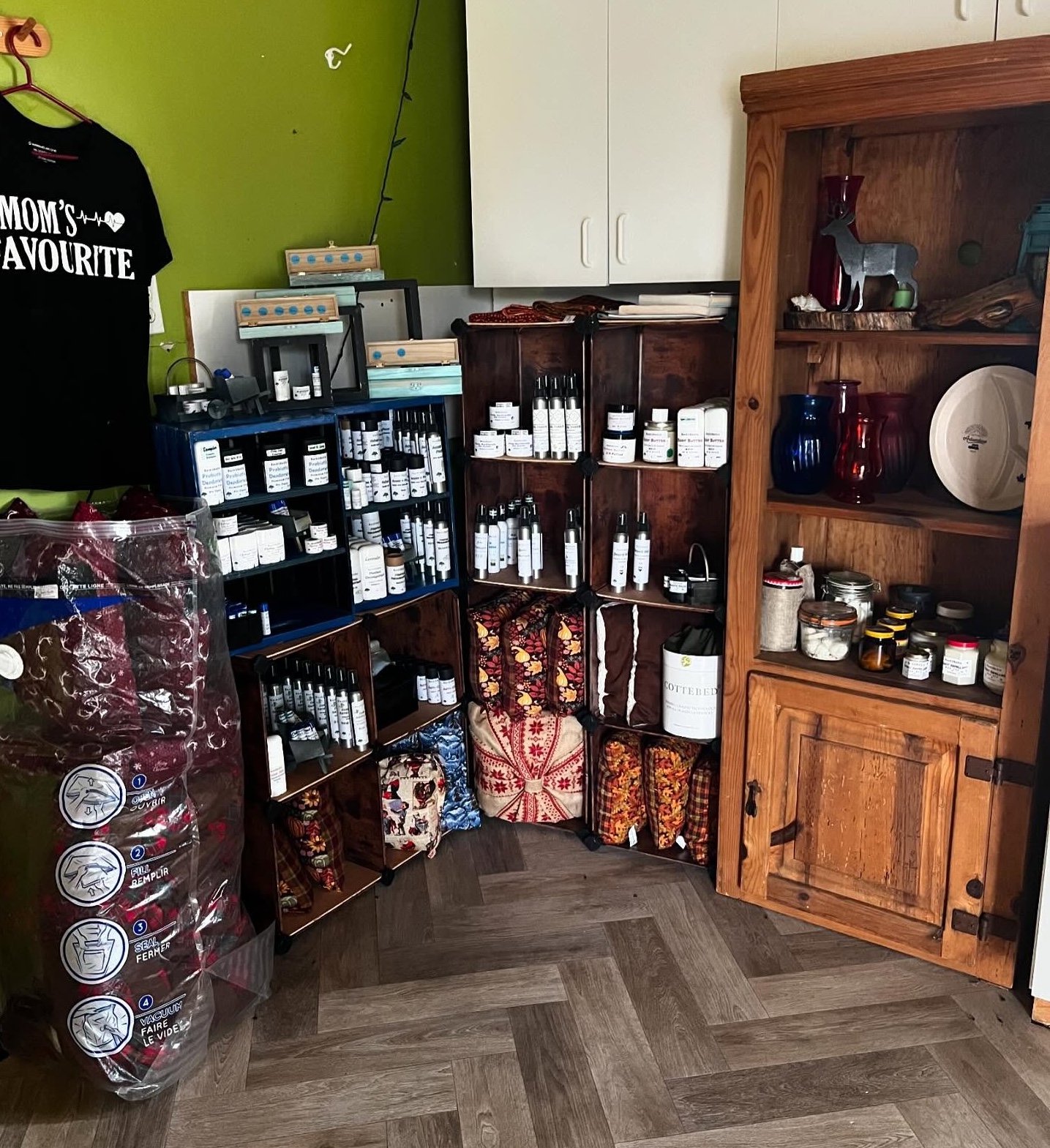wooden shelves filled with handmade goods and t-shirts at Buck Fever Services.