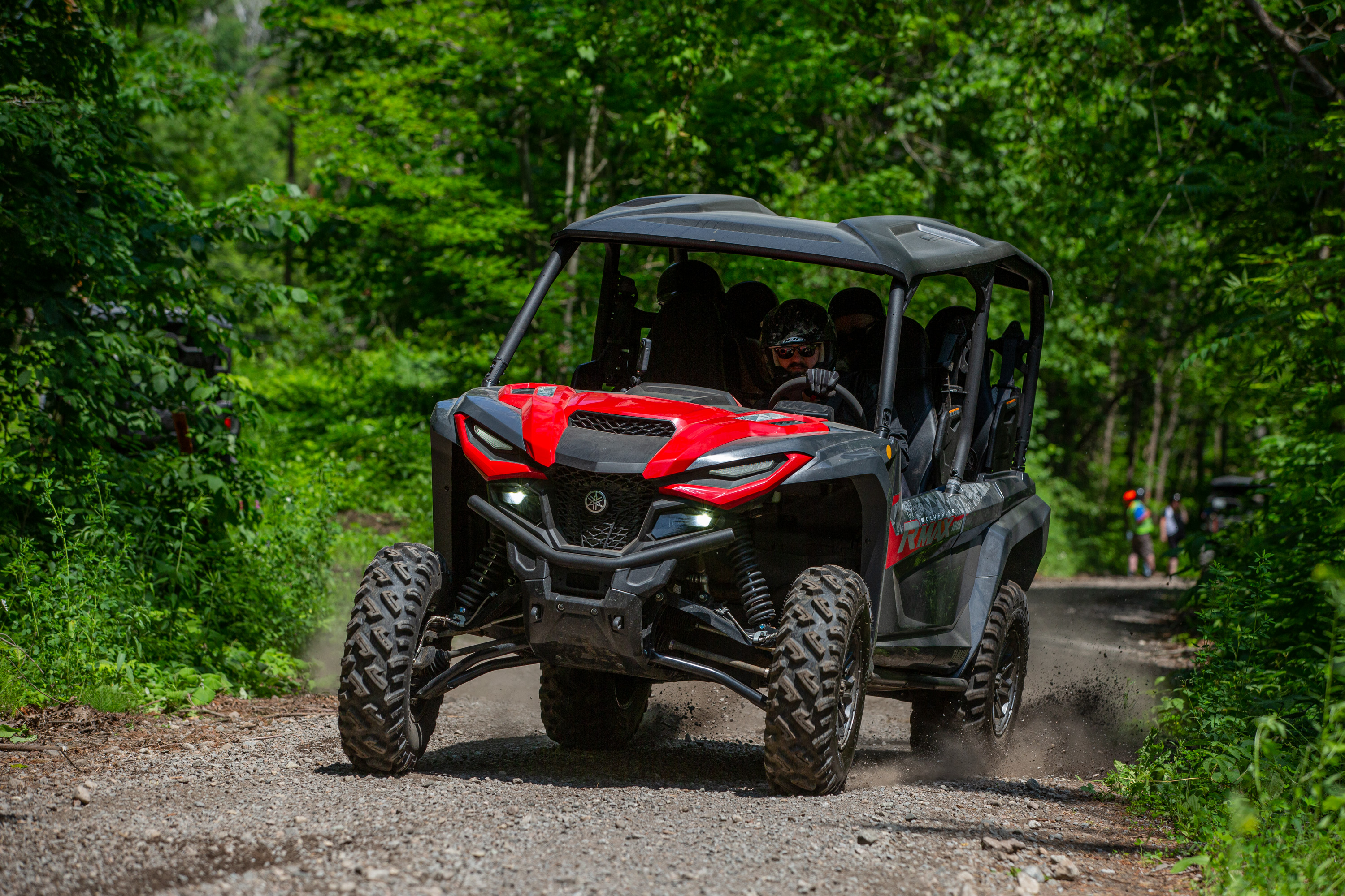 Country music artist Jason McCoy looks relaxed as he speeds down a forested trail in a red UTV during the Rockin' The Trails 2025 event in Tweed.
