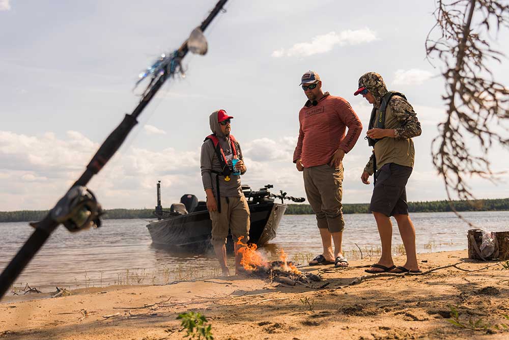 3 anglers having a beach campfire