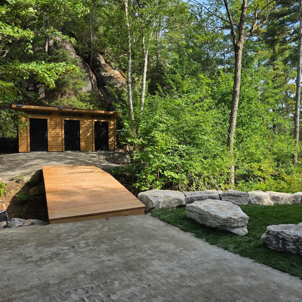 Wooden building with three doors and ramp leading up to it