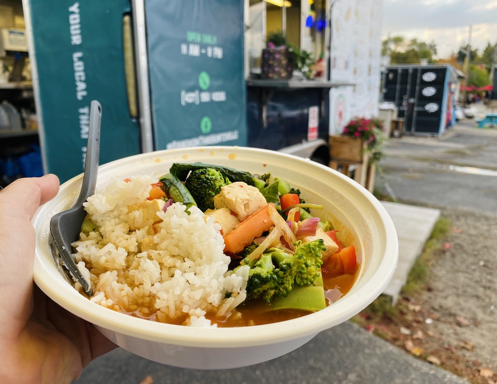 Stir fry dish being held in front of food truck
