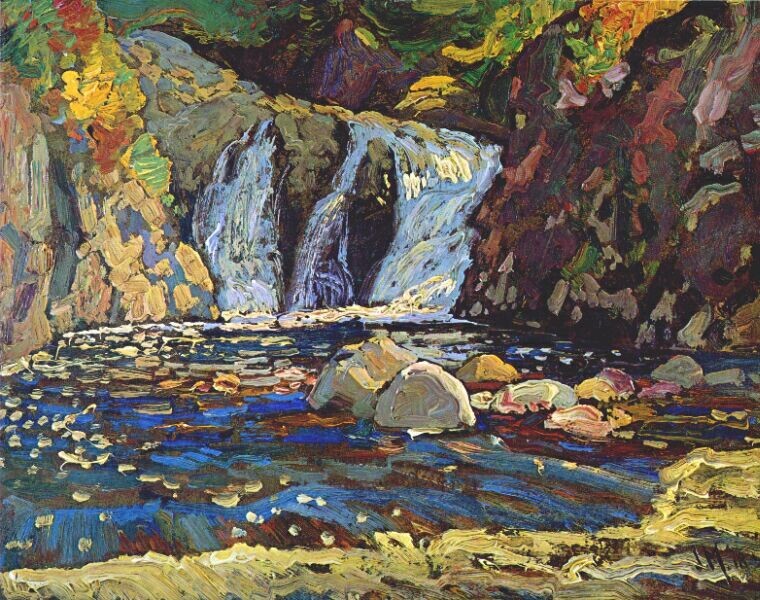 "The Little Falls" by JEH MacDonald: a short, wide waterfall flows down a rocky bank next to a steep, mossy cliff face. Swirling blue pools speckled with green and yellow leaves sit at the bottom, edged with cool tufts of soft grass.