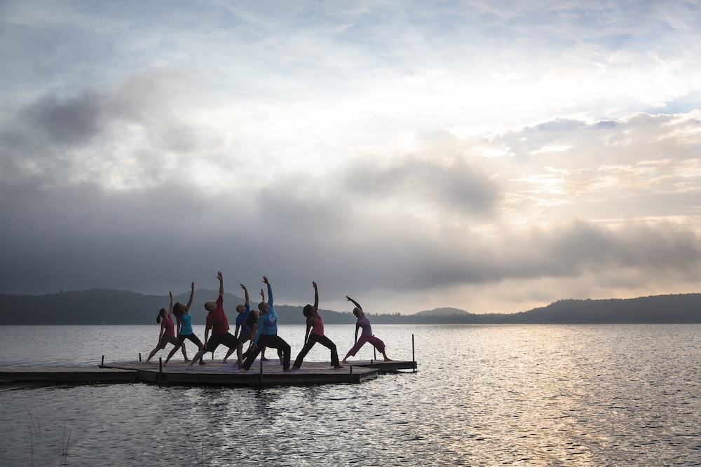 People doing yoga on a dock