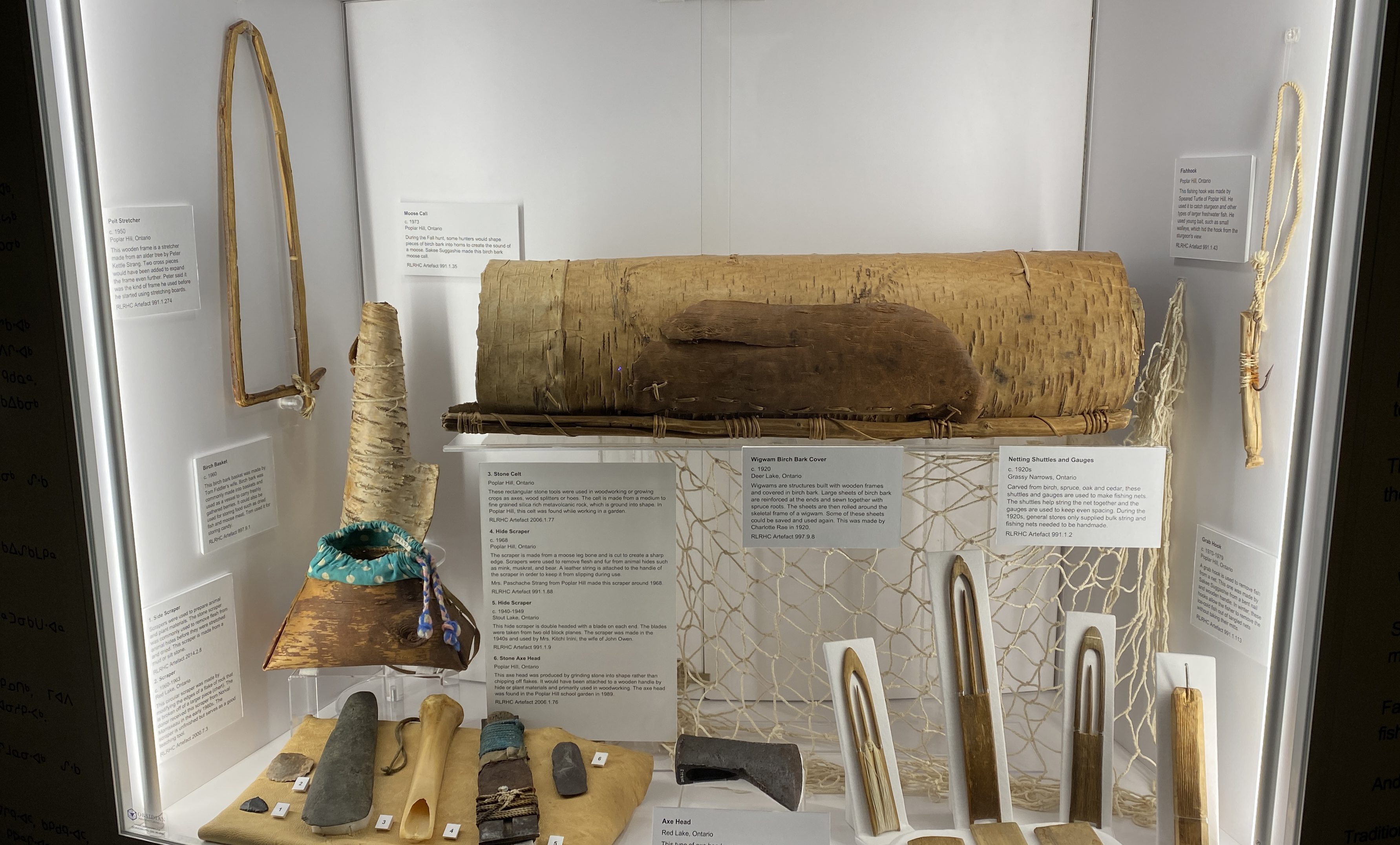 A display from the Red Lake Regional Heritage Centre’s Anishnaabe: The People of the Land exhibit, showcasing traditional tools and artifacts alongside new Woodland Art pieces.