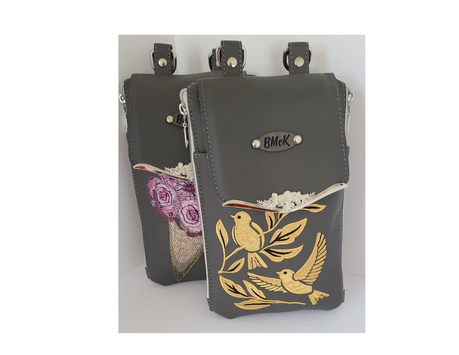 two handmade leather heandbags embroidered with elaborate bird and floral designs made in Elliot Lake Ontario.