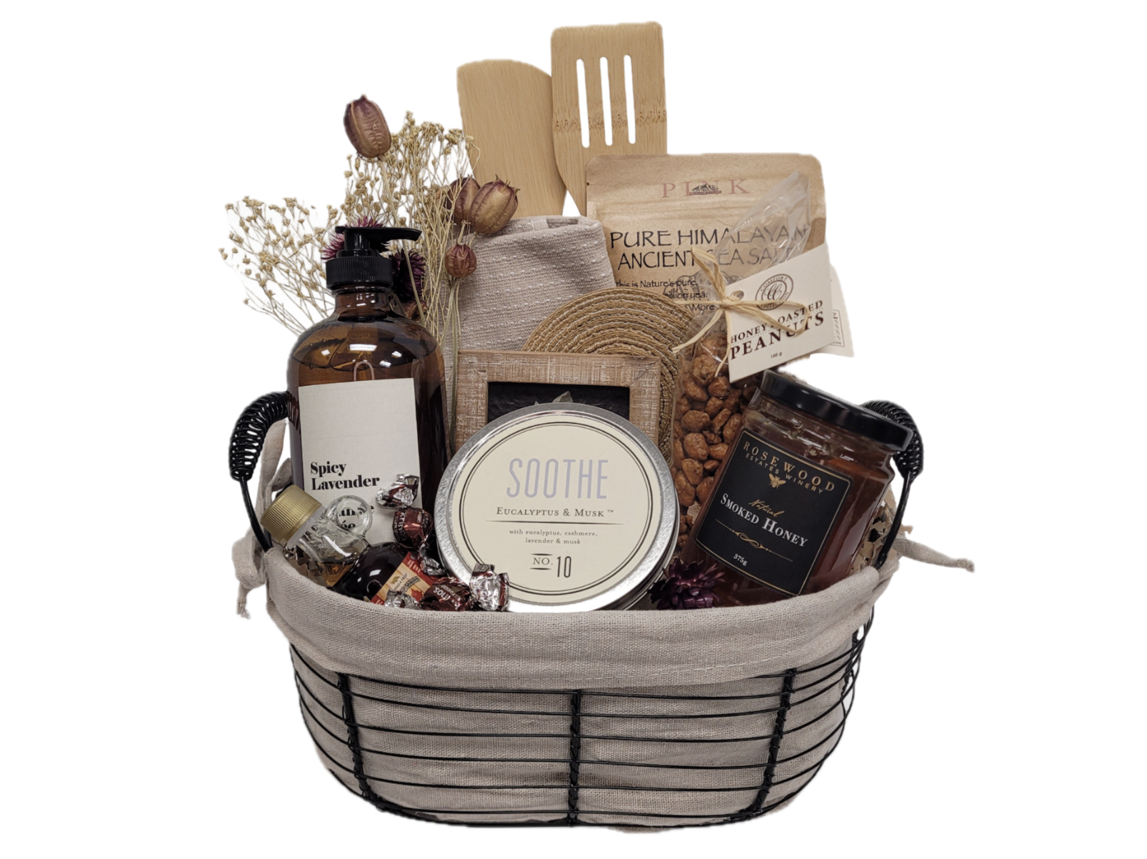 A stylish gift basket filled with lotions, soap, chocolates and kitchen utensils.