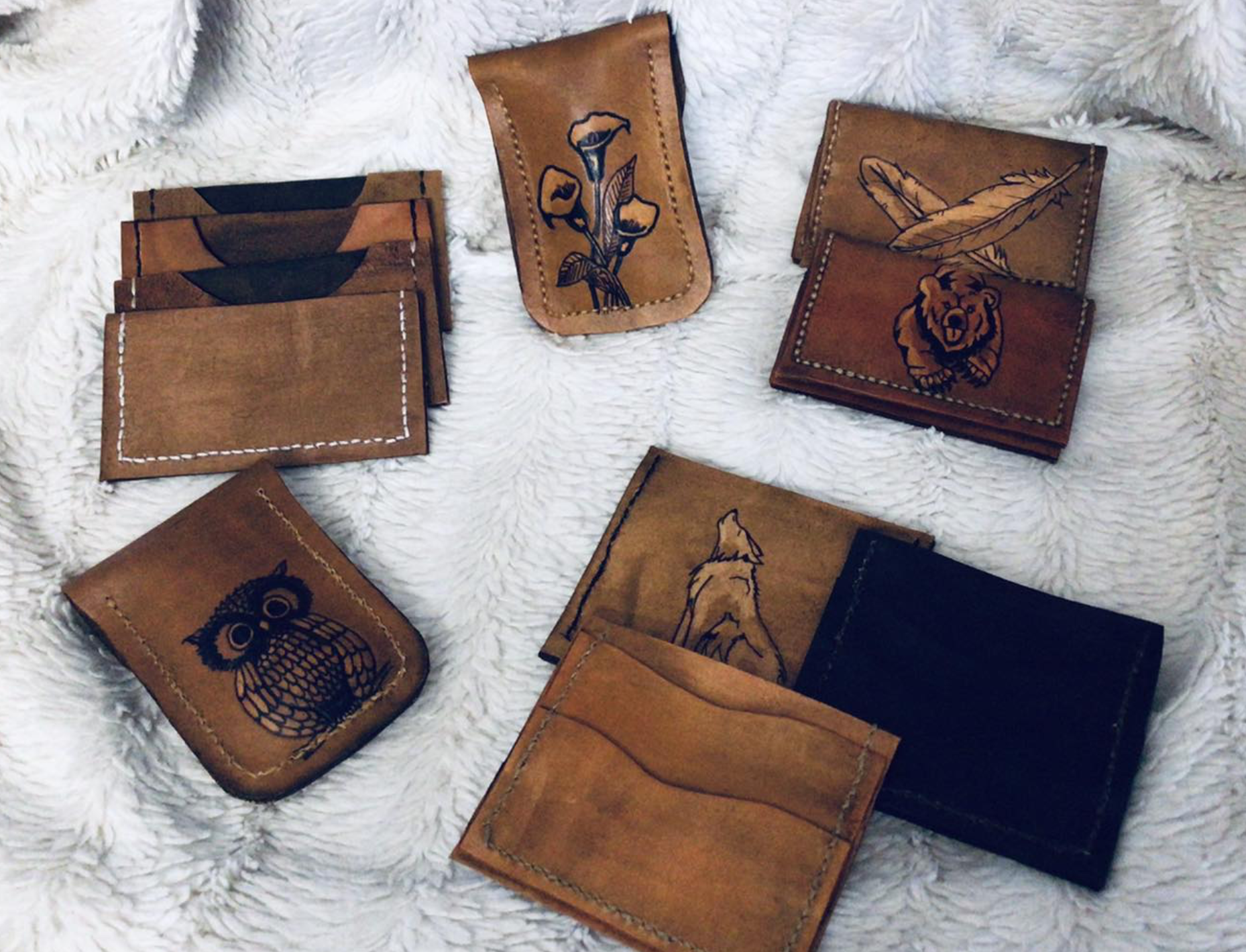 handmade leather wallets artfully adorned with linework animal images made in North Bay Ontario.