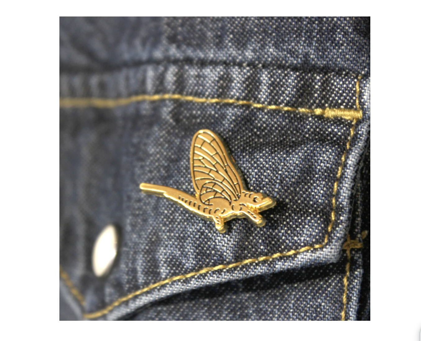 A golden shadfly lapel pin from The FARM store in North Bay, Ontario.