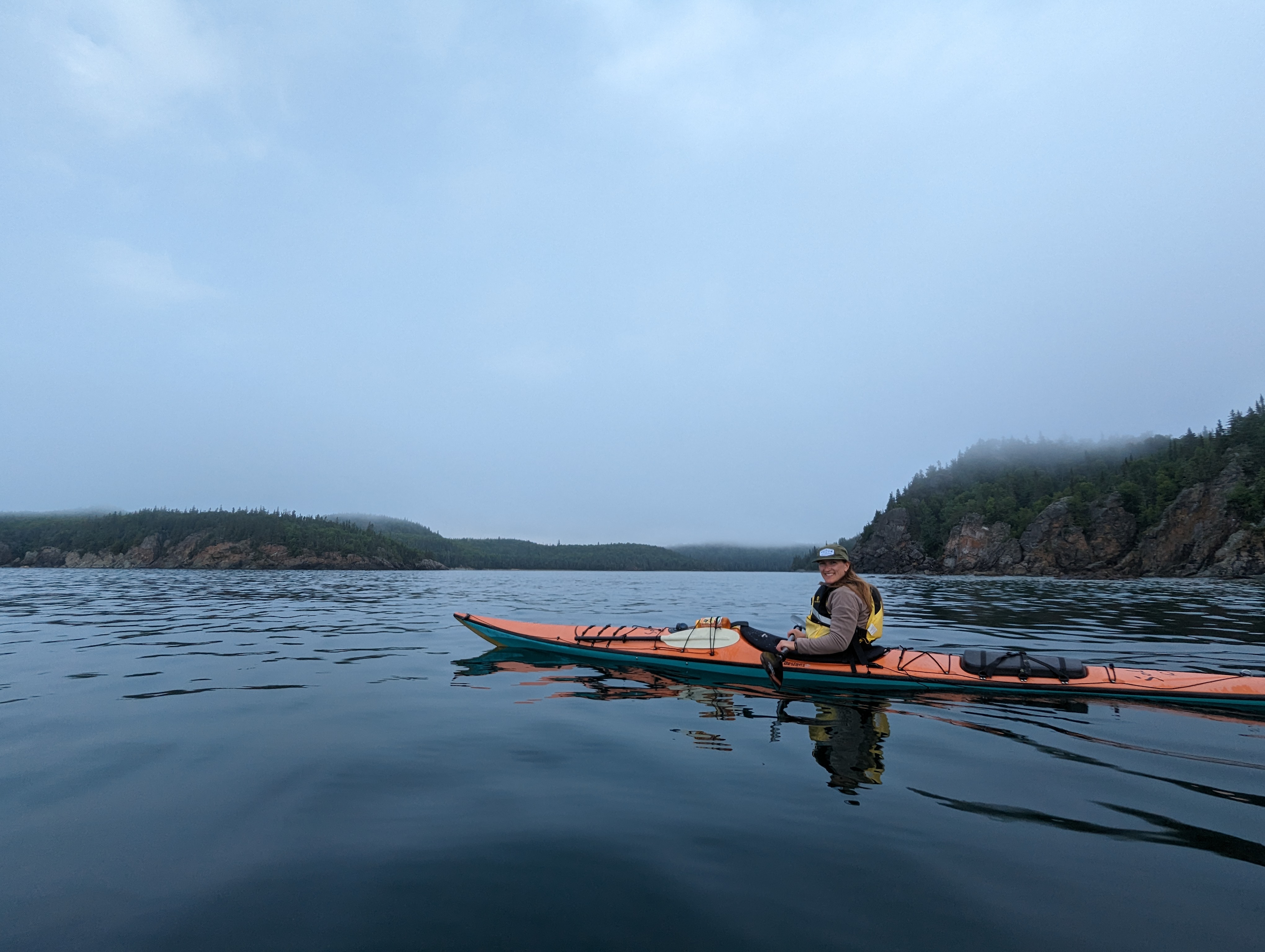Woman in orange sea kayak