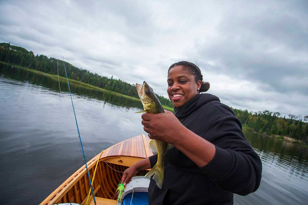 female angler catching walleye