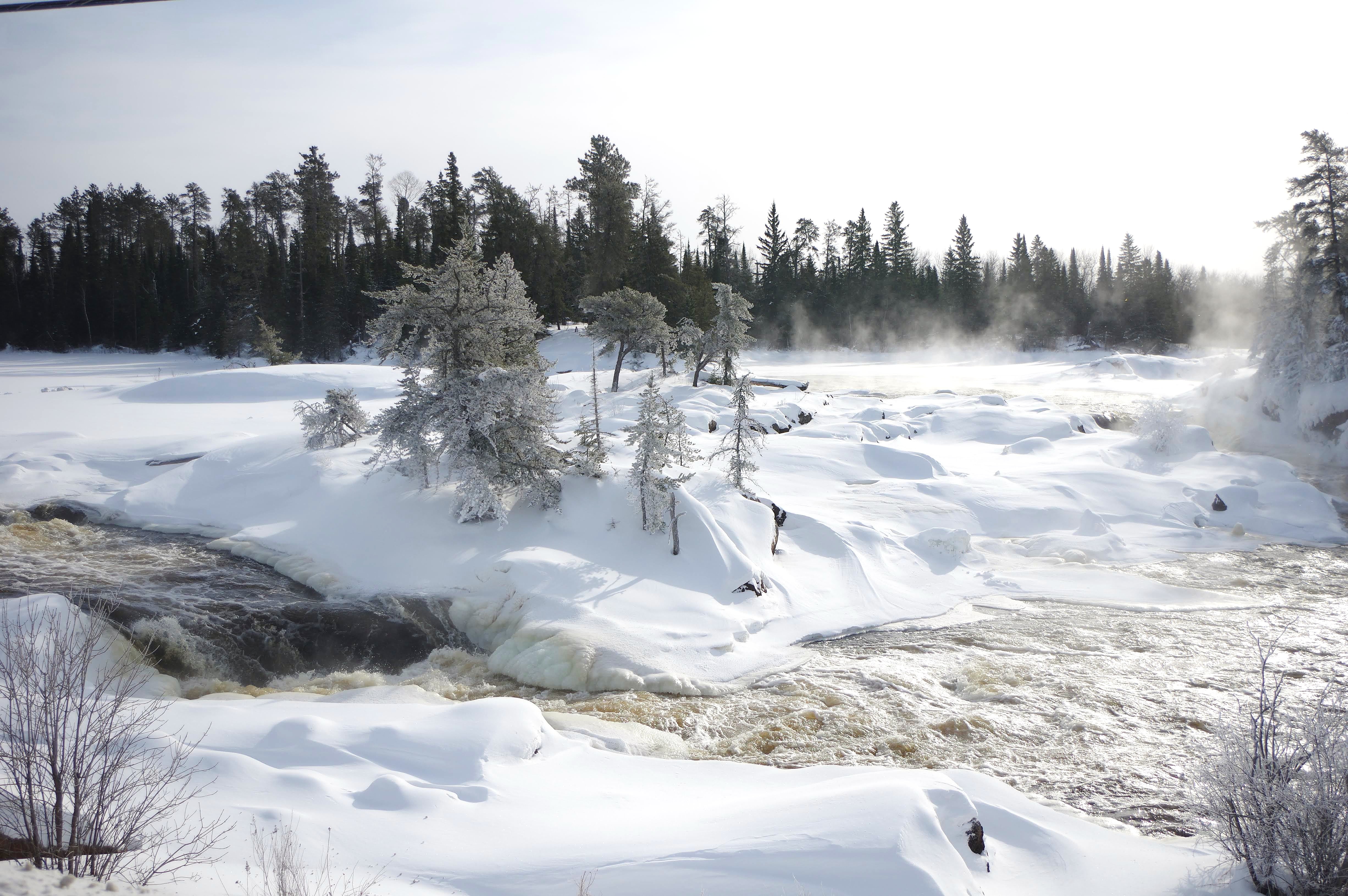 Snowfall blankets the Wabigoon River.