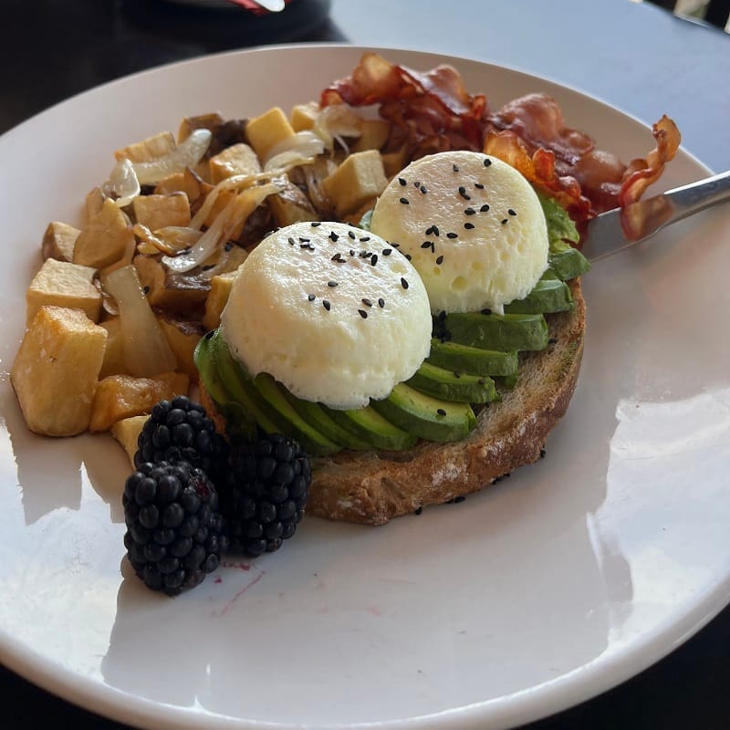 a plate of eggs on a bagel with asparagus and hollandaise at Average Joe's in North Bay.