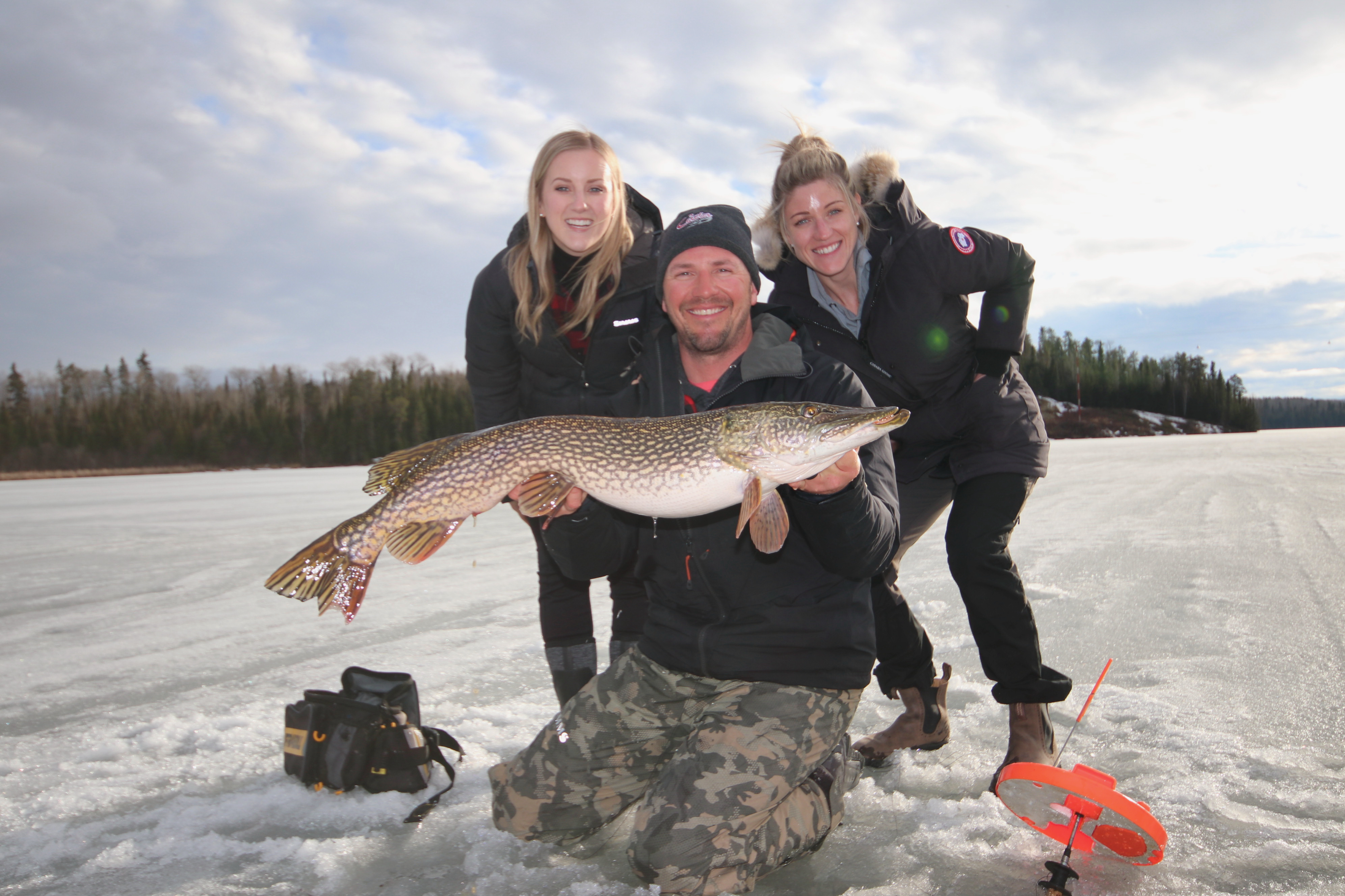 Ice fishing for big northern pike right beside the ice road.