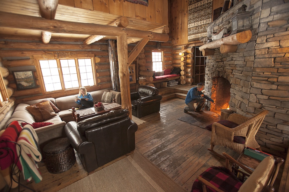 Room in log cabin with cozy fireplace