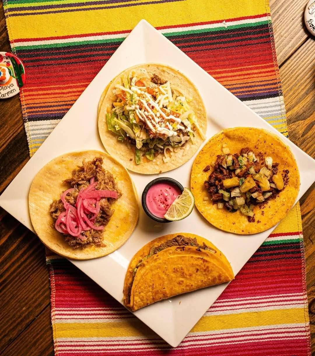 an array of tacos with fresh ingredients on a colourful woven placement at La Casa de Maria in North Bay.