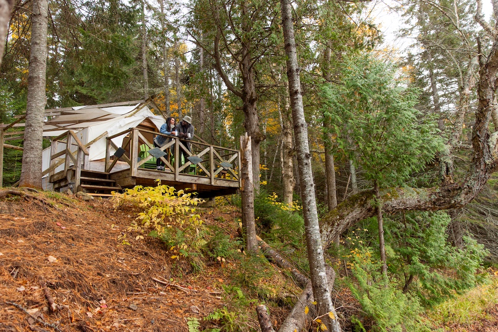 People standing on platform in front of cabin
