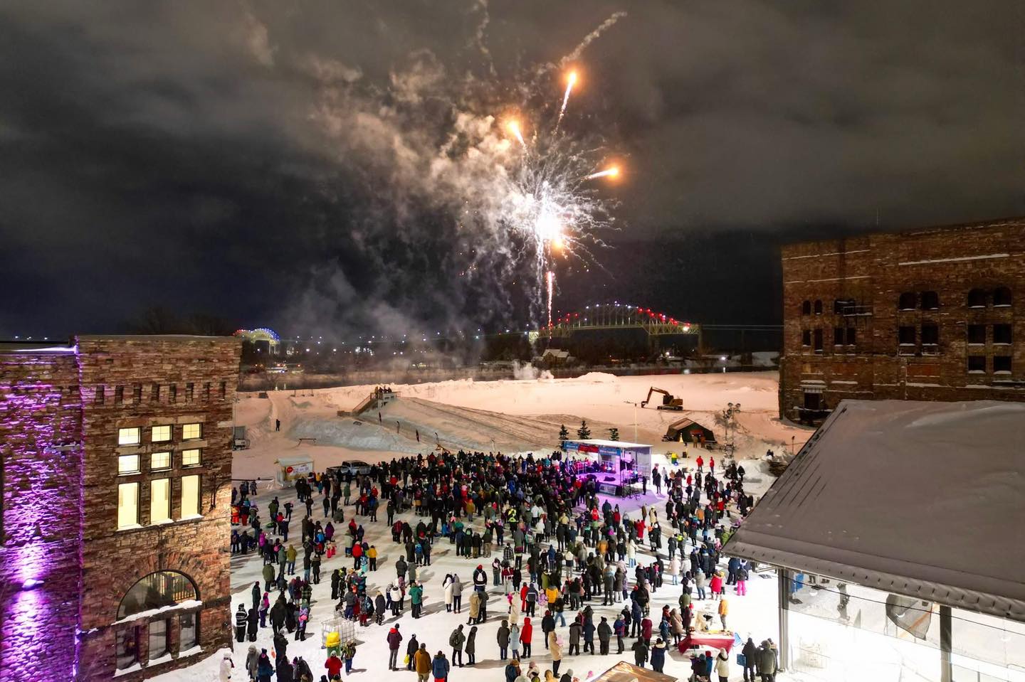 visitors gather on a snowy night to watch the fireworks at the opening ceremonies at the Bon Soo Winter Carnival in Sault Ste. Marie.