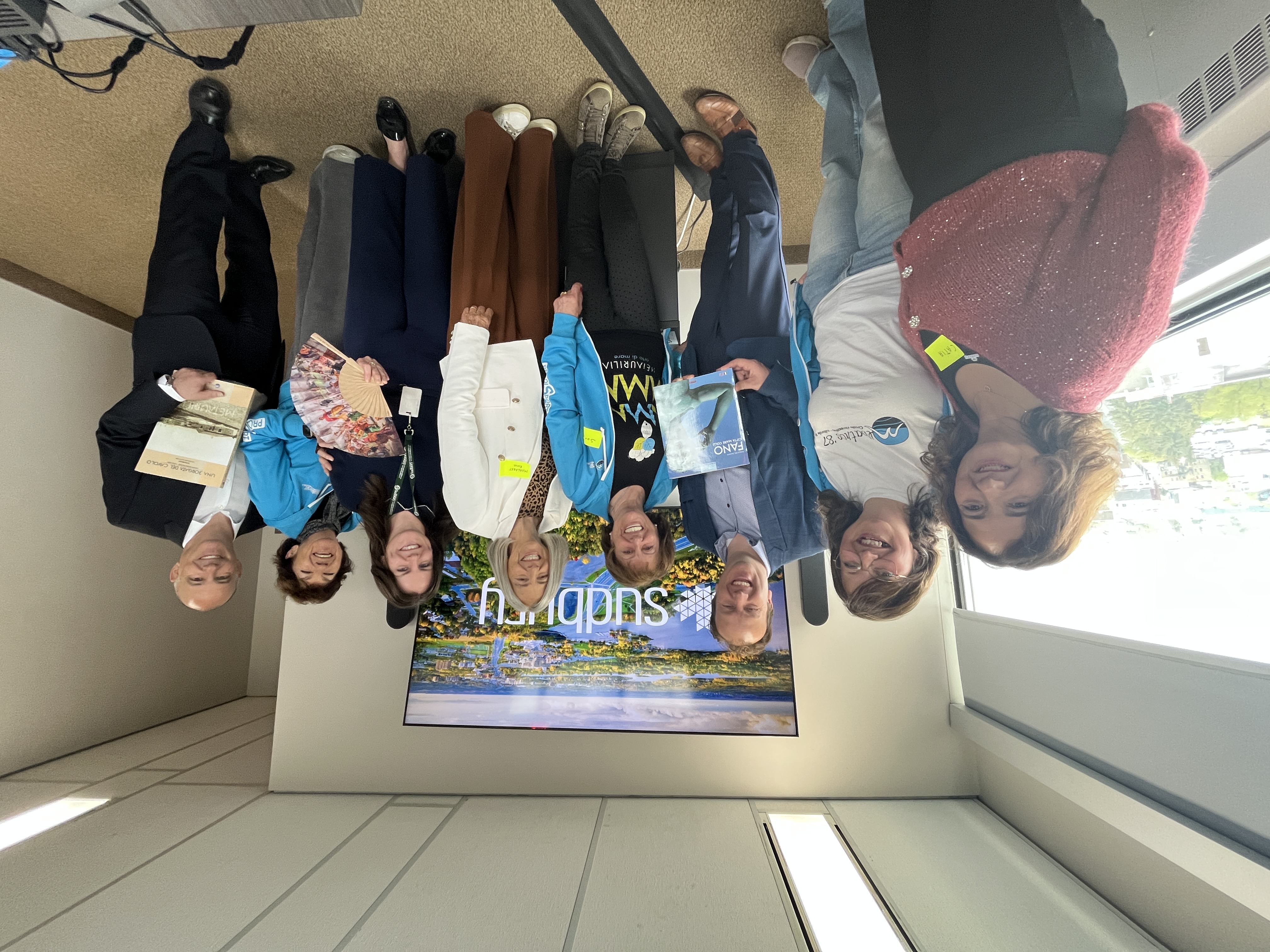 Smiling visitors from Fano, Italy stand together with staff at Sudbury Tourism.