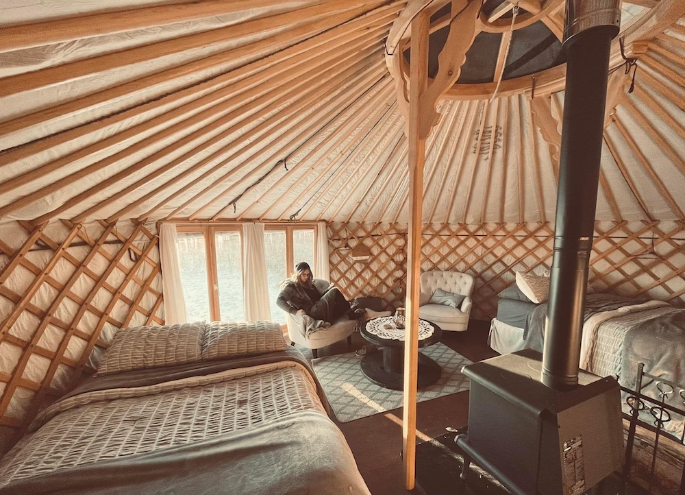 Woman relaxes inside glamping dome