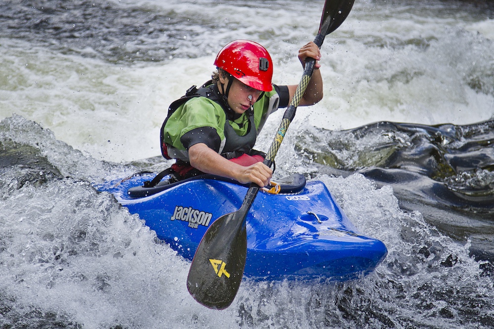 Person paddling a whitewater kayak
