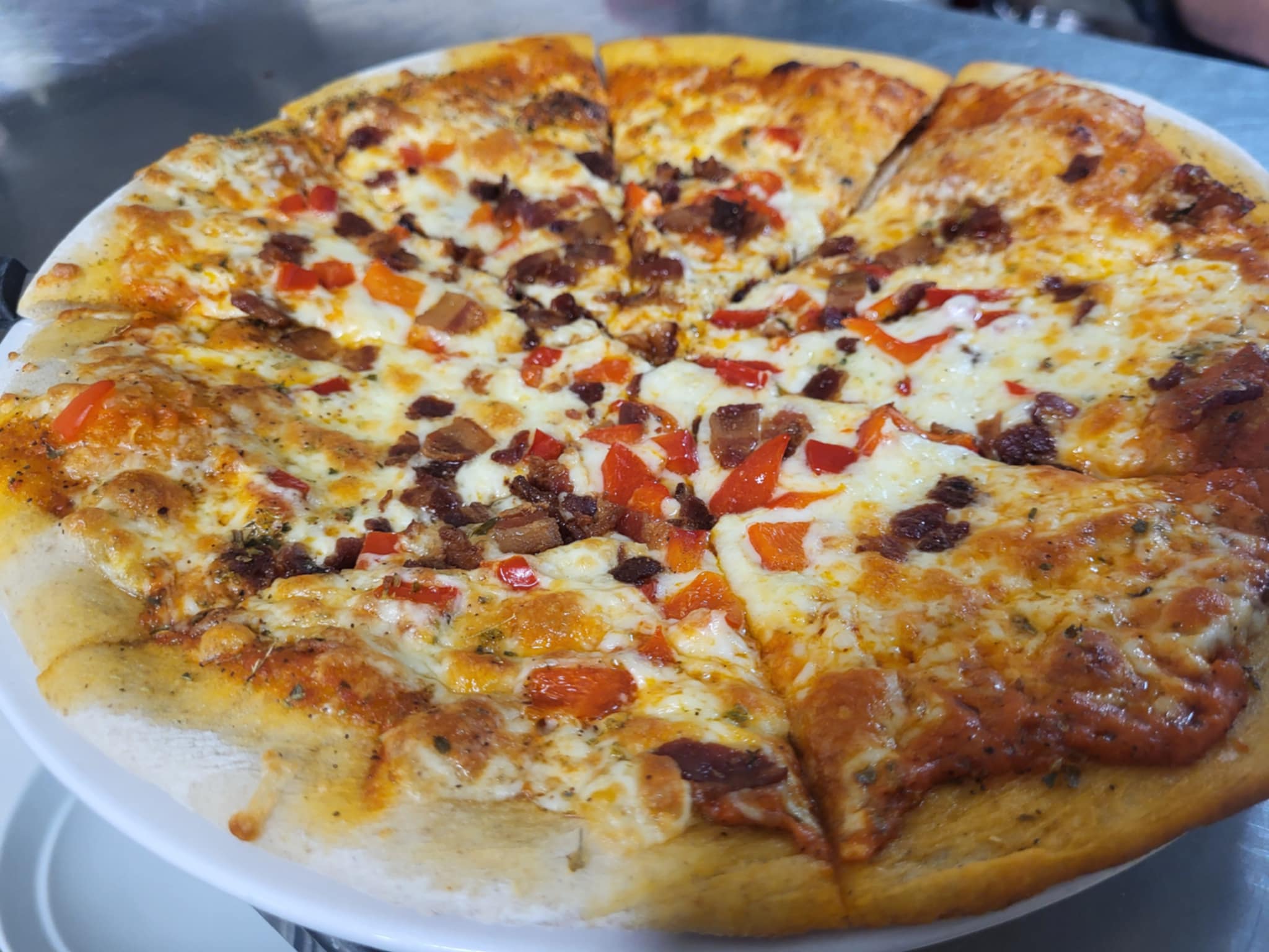 Gooey and golden pizza topped with colourful vegetables from Bella Vita Cucina. 