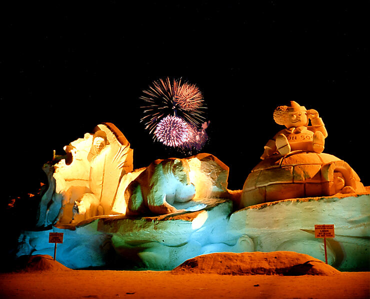 elaborate snow sculptures lit up with coloured lights in the night at the Bon Soo Winter Carnival in Sault Ste. Marie.