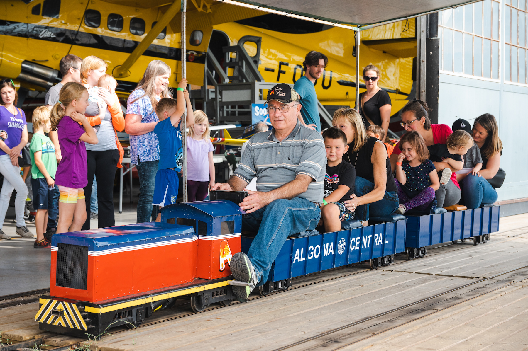 families ride behind a conductor in a miniature train that runs through the Bushplane Heritage Centre in Sault Ste. Marie.