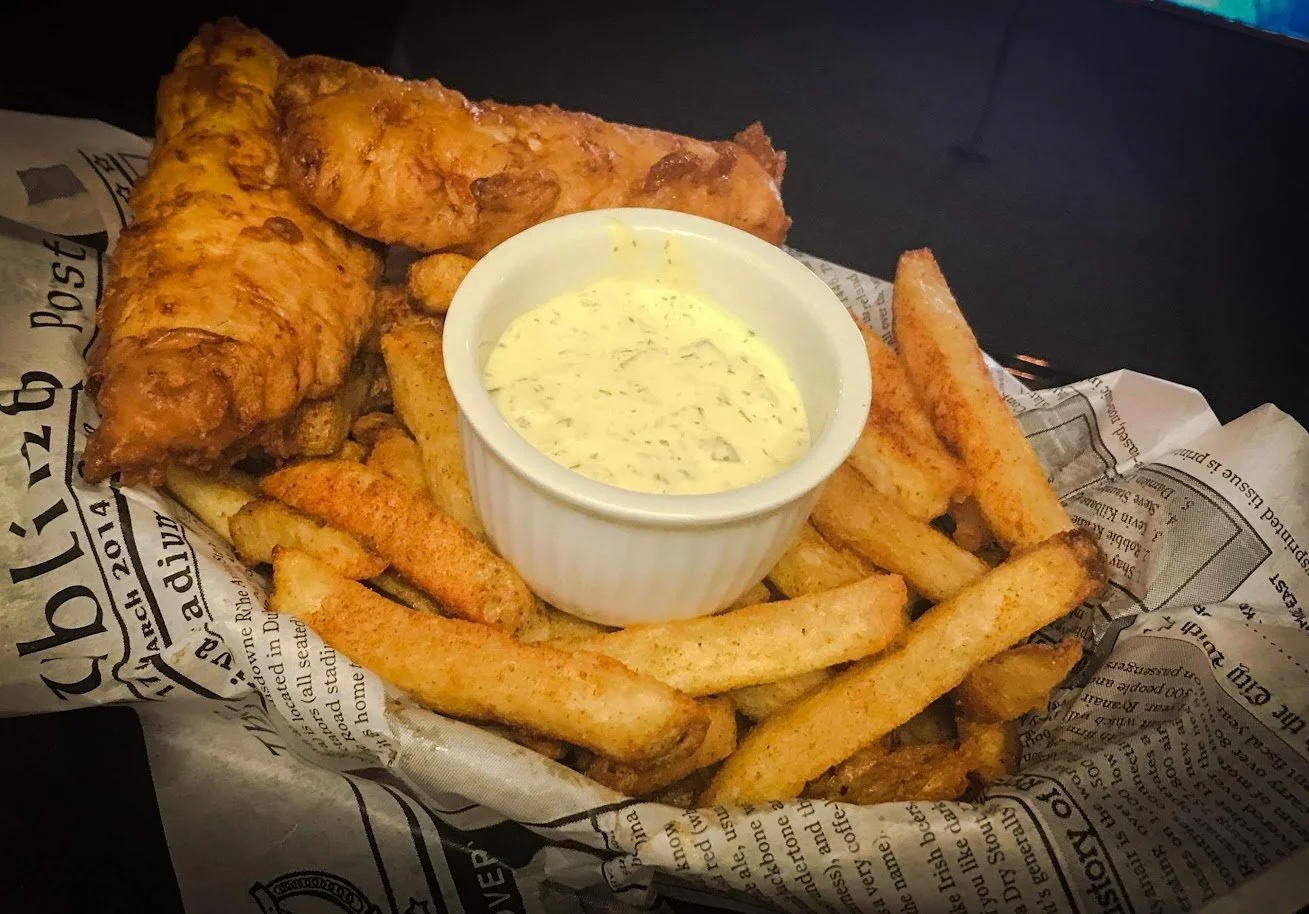 golden crispy pub fries and battered fish with tartar dipping sauce from The Whiskey Barrel. 